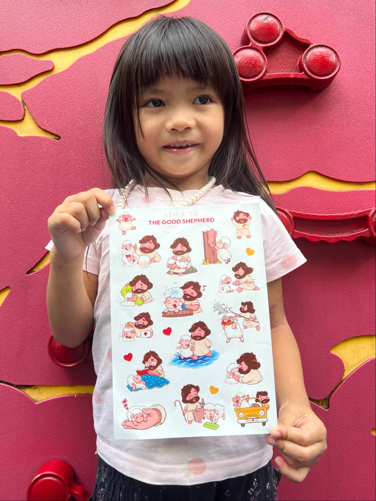 Child holding a sheet of stickers in front of a colorful wall